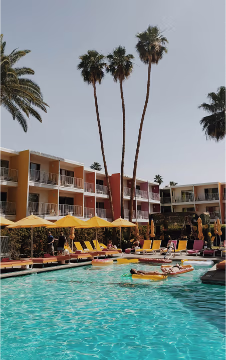 A hotel pool with palms
