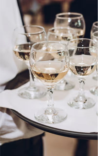 Glasses of wine being carried by a waiter
